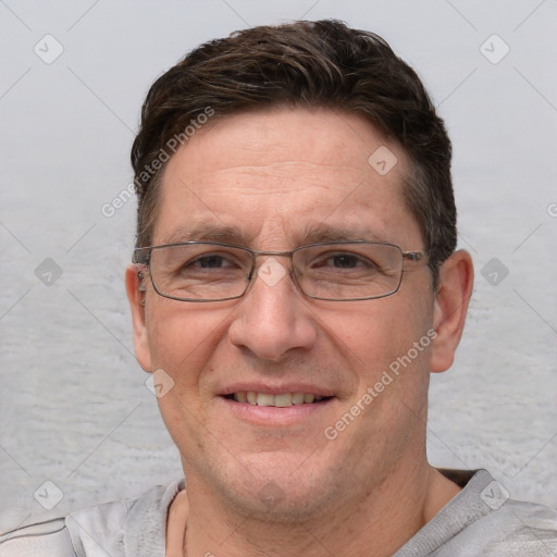 Joyful white adult male with short  brown hair and grey eyes