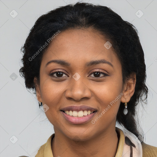 Joyful black young-adult female with long  black hair and brown eyes