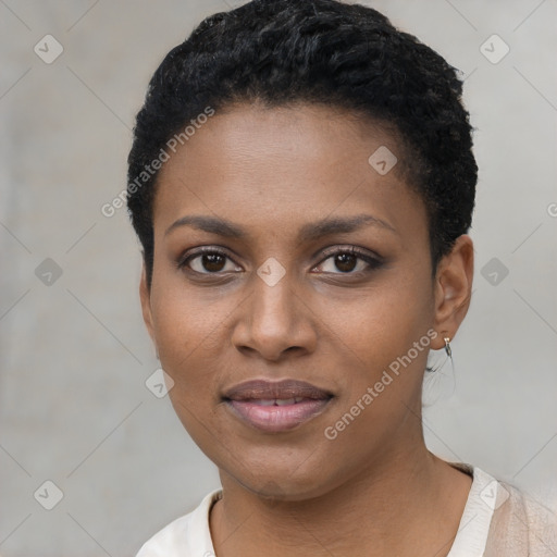 Joyful black young-adult female with short  black hair and brown eyes