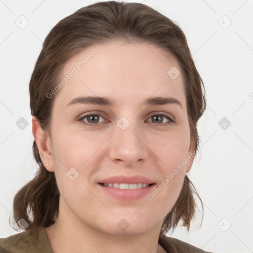 Joyful white young-adult female with medium  brown hair and grey eyes