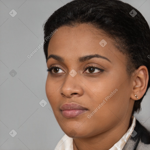 Joyful black young-adult female with short  black hair and brown eyes