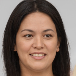 Joyful white adult female with long  brown hair and brown eyes