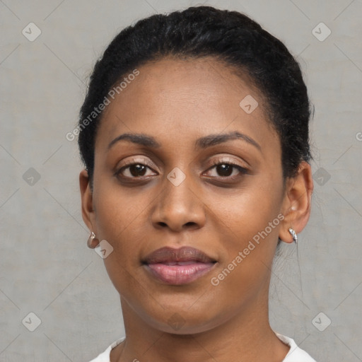 Joyful black young-adult female with short  black hair and brown eyes