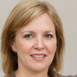 Joyful white adult female with medium  brown hair and grey eyes