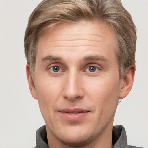 Joyful white adult male with short  brown hair and grey eyes