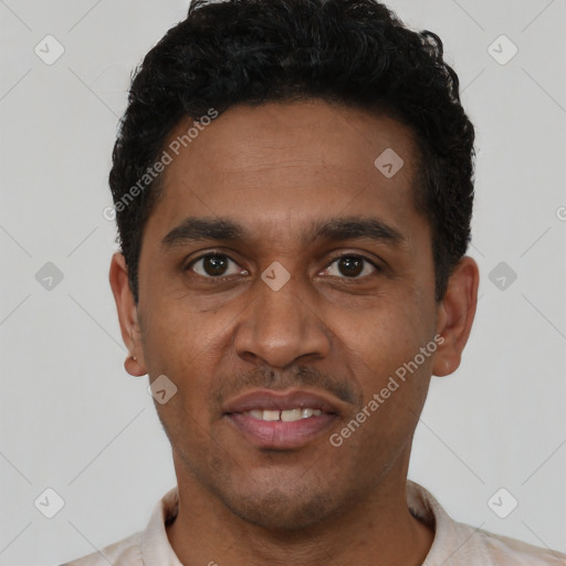 Joyful black young-adult male with short  black hair and brown eyes