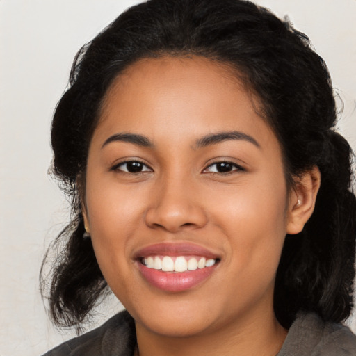 Joyful latino young-adult female with medium  black hair and brown eyes