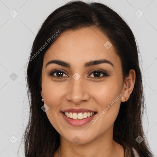 Joyful latino young-adult female with long  brown hair and brown eyes