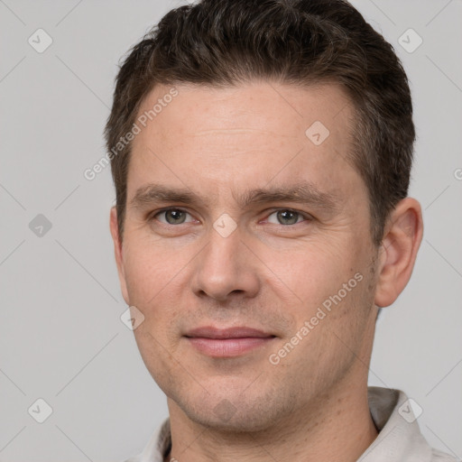 Joyful white adult male with short  brown hair and grey eyes