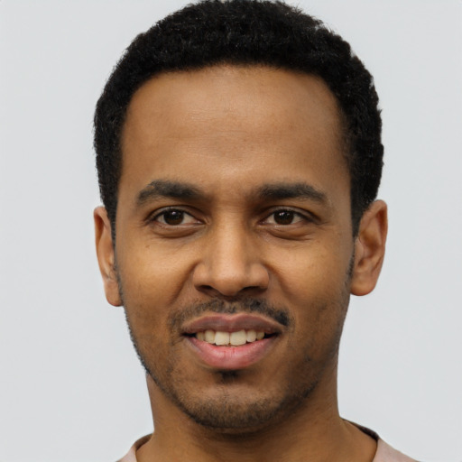 Joyful black young-adult male with short  black hair and brown eyes
