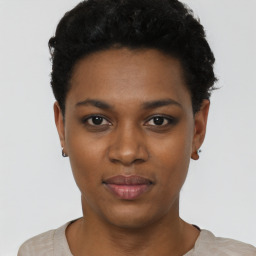Joyful black young-adult female with short  black hair and brown eyes