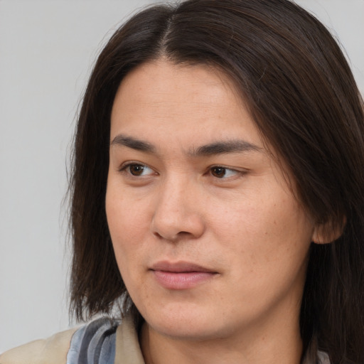 Joyful asian young-adult female with long  brown hair and brown eyes