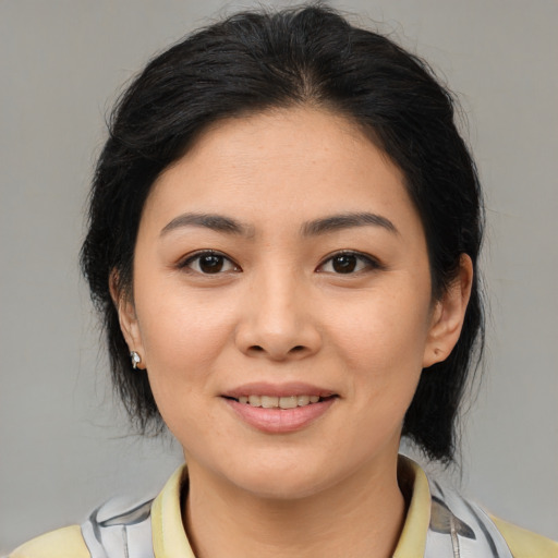 Joyful latino young-adult female with medium  brown hair and brown eyes