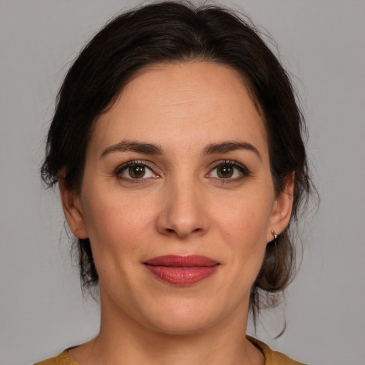 Joyful white adult female with medium  brown hair and brown eyes