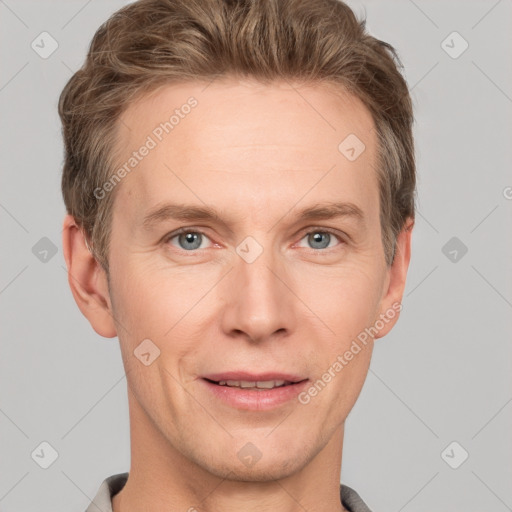 Joyful white adult male with short  brown hair and grey eyes