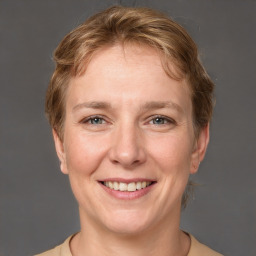 Joyful white adult female with short  brown hair and grey eyes