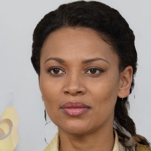 Joyful black adult female with medium  black hair and brown eyes