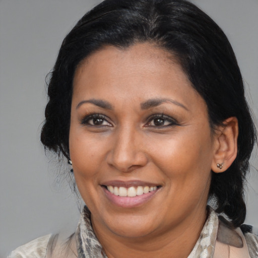 Joyful asian adult female with medium  brown hair and brown eyes