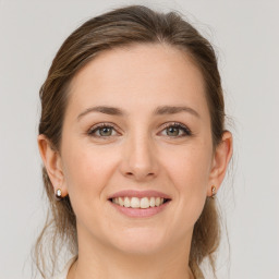 Joyful white young-adult female with medium  brown hair and grey eyes