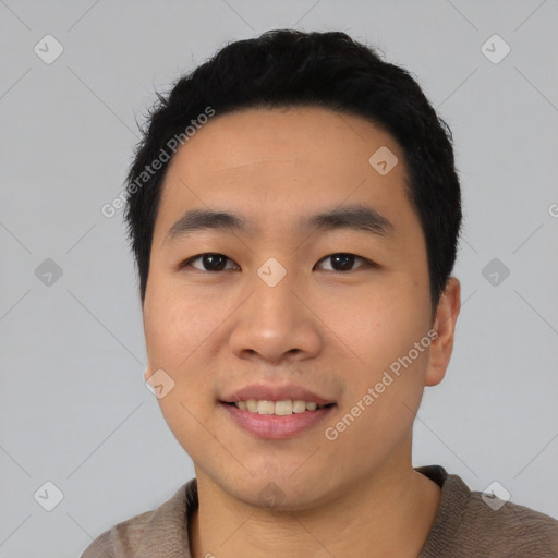 Joyful asian young-adult male with short  black hair and brown eyes