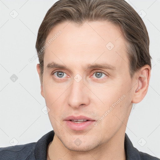 Joyful white young-adult male with short  brown hair and grey eyes