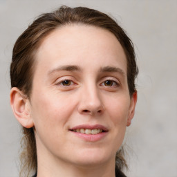 Joyful white young-adult female with medium  brown hair and grey eyes