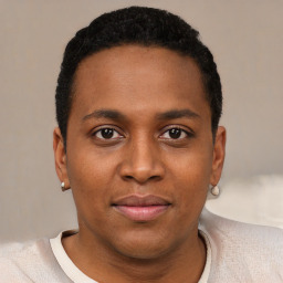 Joyful black young-adult male with short  black hair and brown eyes