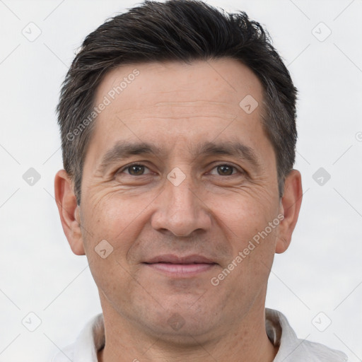 Joyful white adult male with short  brown hair and brown eyes