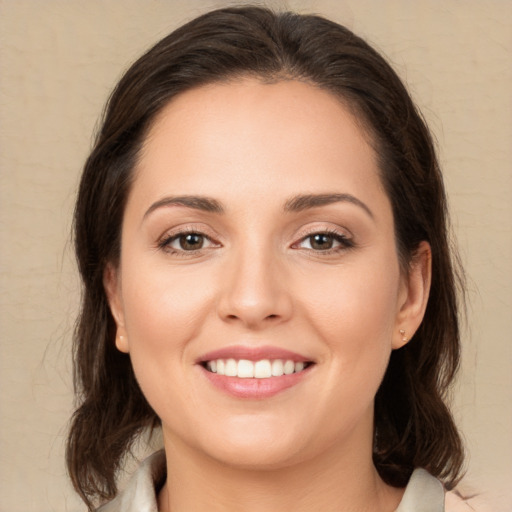 Joyful white young-adult female with medium  brown hair and brown eyes