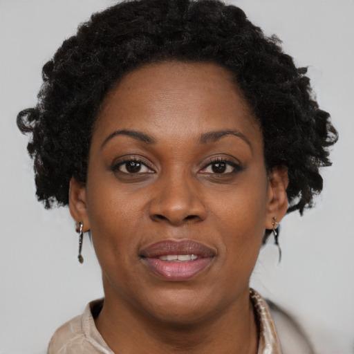 Joyful black adult female with short  brown hair and brown eyes