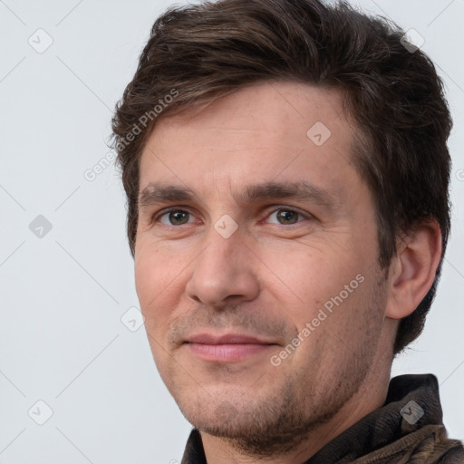 Joyful white adult male with short  brown hair and brown eyes