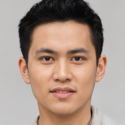 Joyful asian young-adult male with short  brown hair and brown eyes