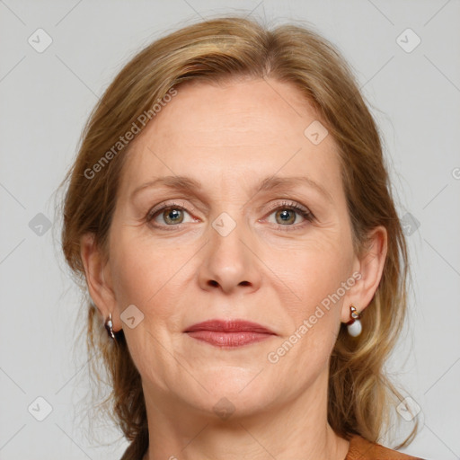 Joyful white adult female with medium  brown hair and blue eyes