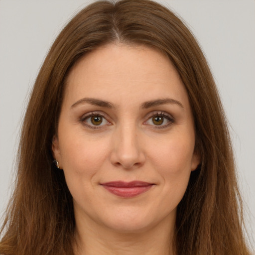 Joyful white young-adult female with long  brown hair and brown eyes