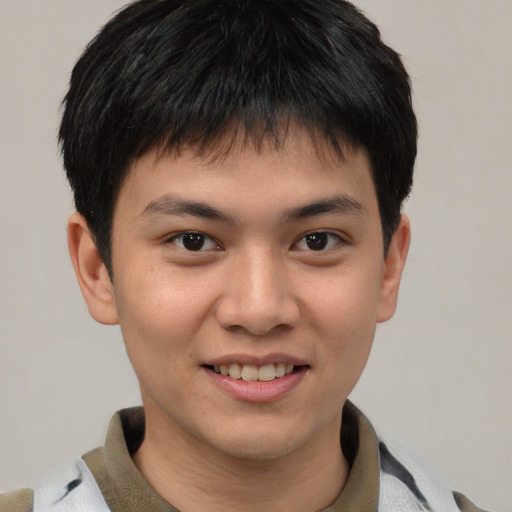 Joyful asian young-adult male with short  brown hair and brown eyes