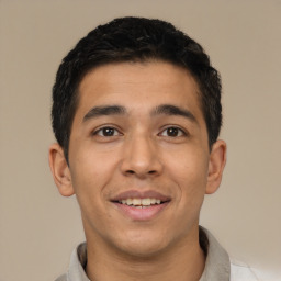 Joyful latino young-adult male with short  black hair and brown eyes