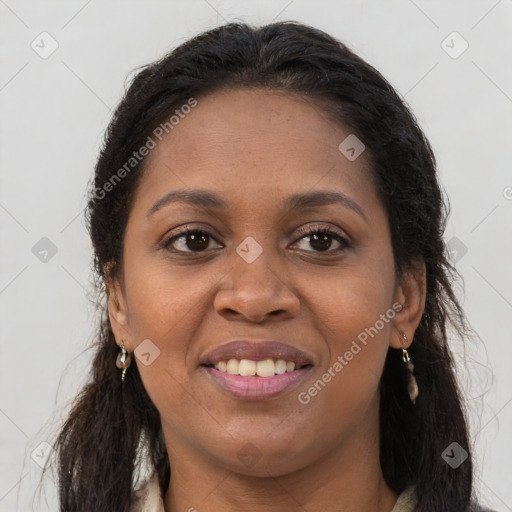 Joyful black young-adult female with long  brown hair and brown eyes