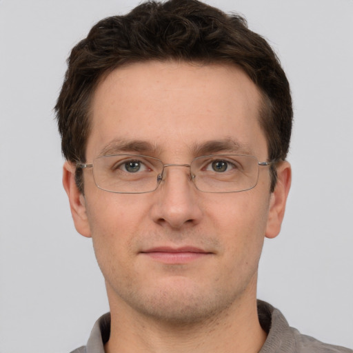 Joyful white adult male with short  brown hair and grey eyes