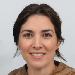 Joyful white adult female with medium  brown hair and brown eyes