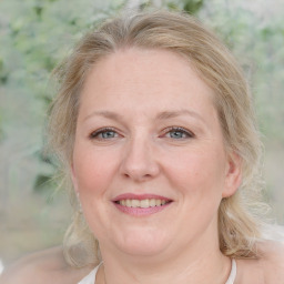 Joyful white adult female with medium  brown hair and blue eyes