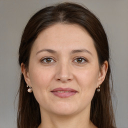 Joyful white adult female with medium  brown hair and brown eyes