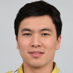 Joyful asian young-adult male with short  black hair and brown eyes