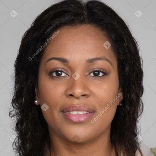 Joyful black young-adult female with long  brown hair and brown eyes