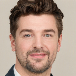 Joyful white adult male with short  brown hair and grey eyes