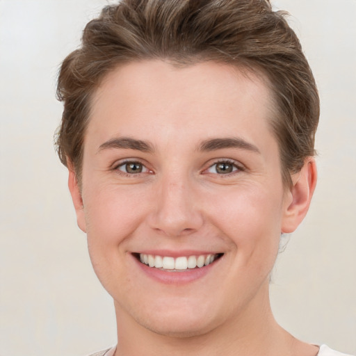 Joyful white young-adult female with short  brown hair and grey eyes