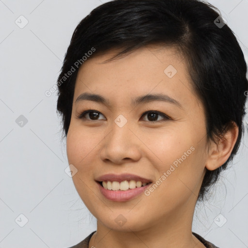 Joyful asian young-adult female with medium  black hair and brown eyes