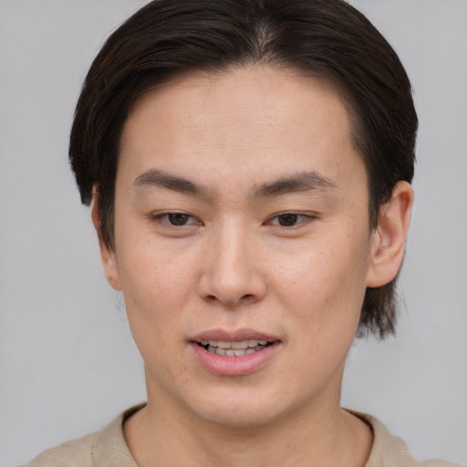 Joyful asian young-adult female with short  brown hair and brown eyes