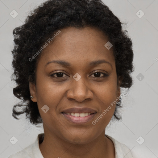 Joyful black adult female with short  brown hair and brown eyes