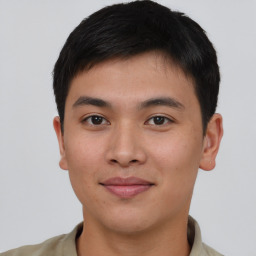 Joyful asian young-adult male with short  brown hair and brown eyes