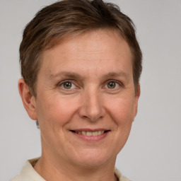 Joyful white adult female with short  brown hair and grey eyes